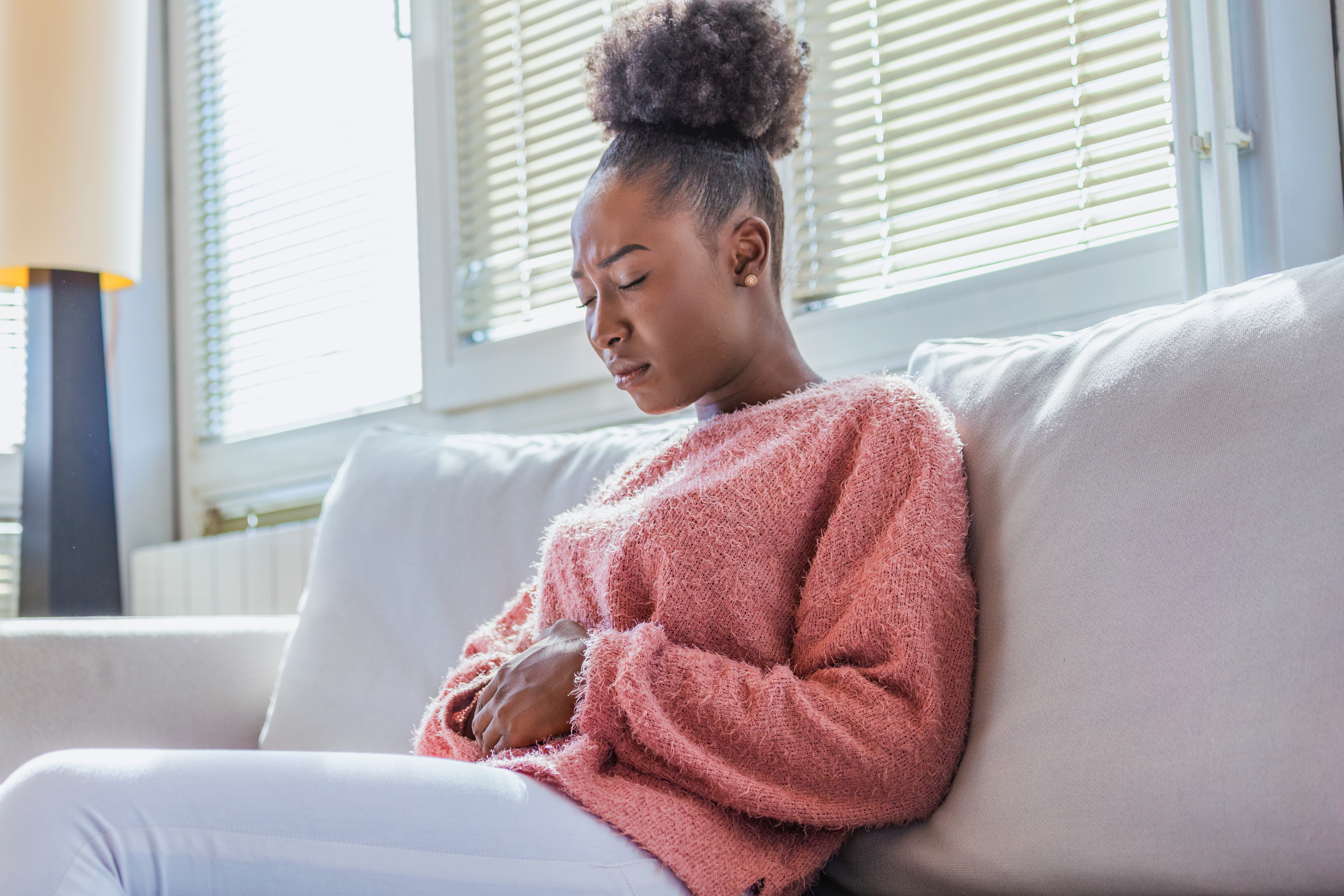 Women with endometriosis holding abdomen in pain and discomfort