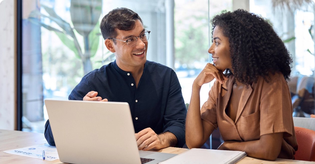 Two people collaborating at a laptop